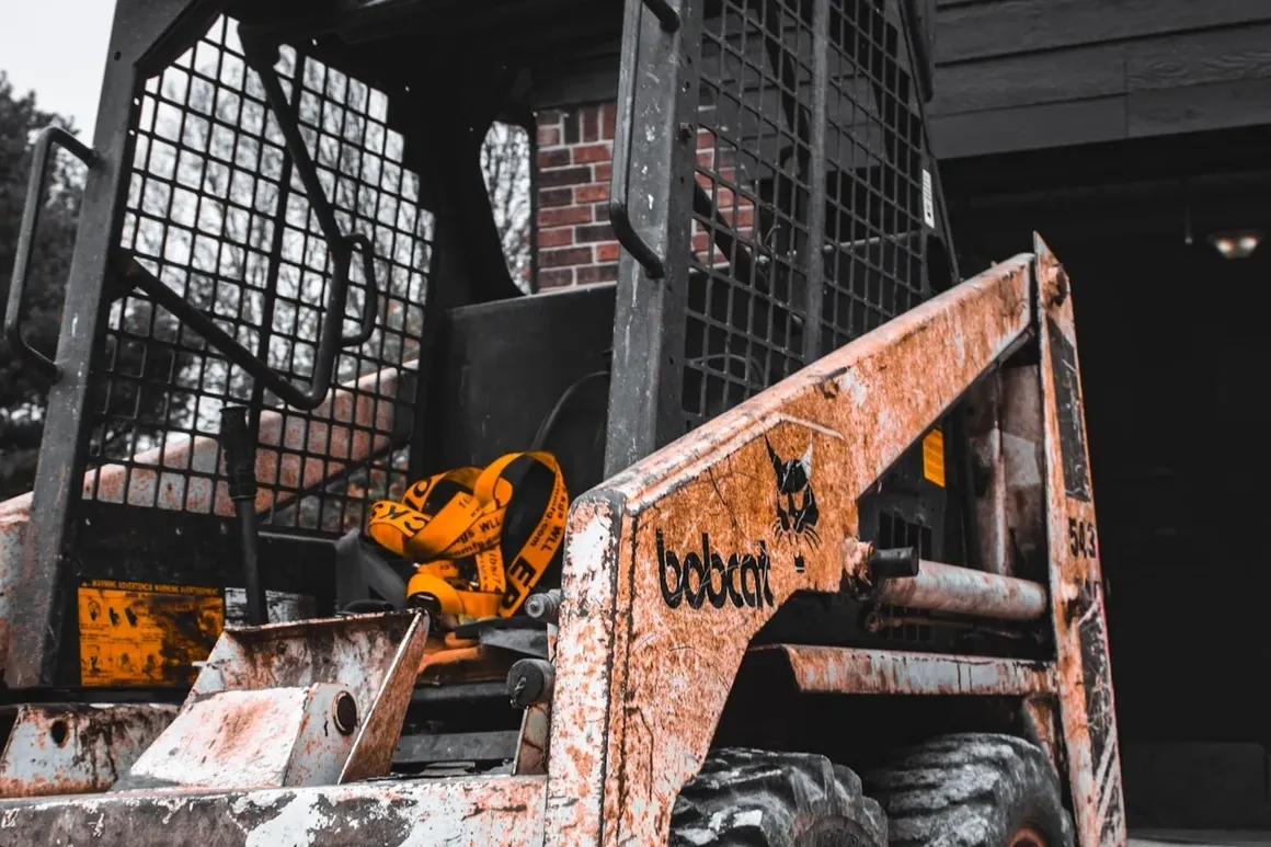 Skid steer loader clearing a rural property in central Indiana