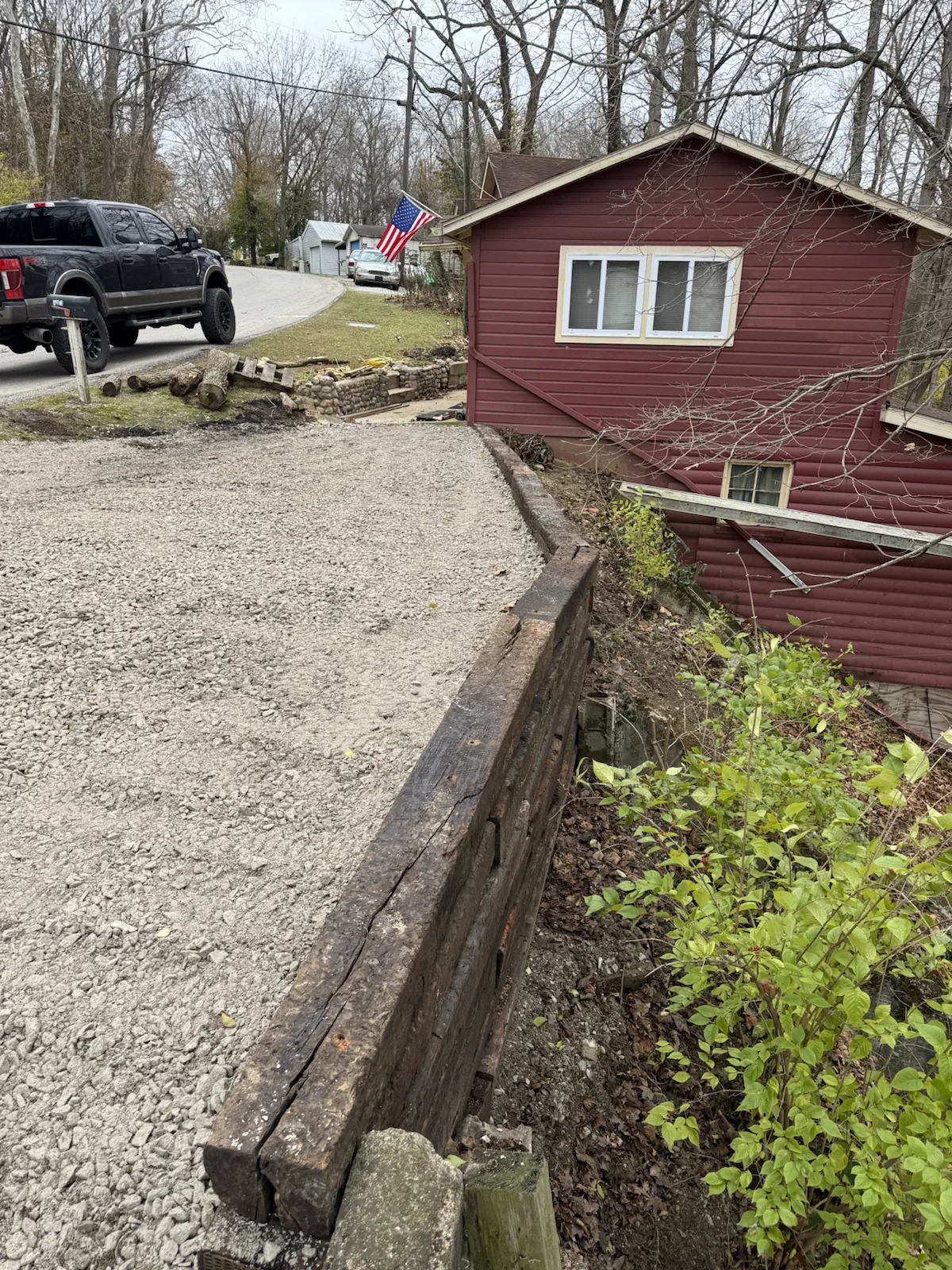 Completed gravel driveway and retaining wall at a red cabin near the water in central Indiana (photo 3)
