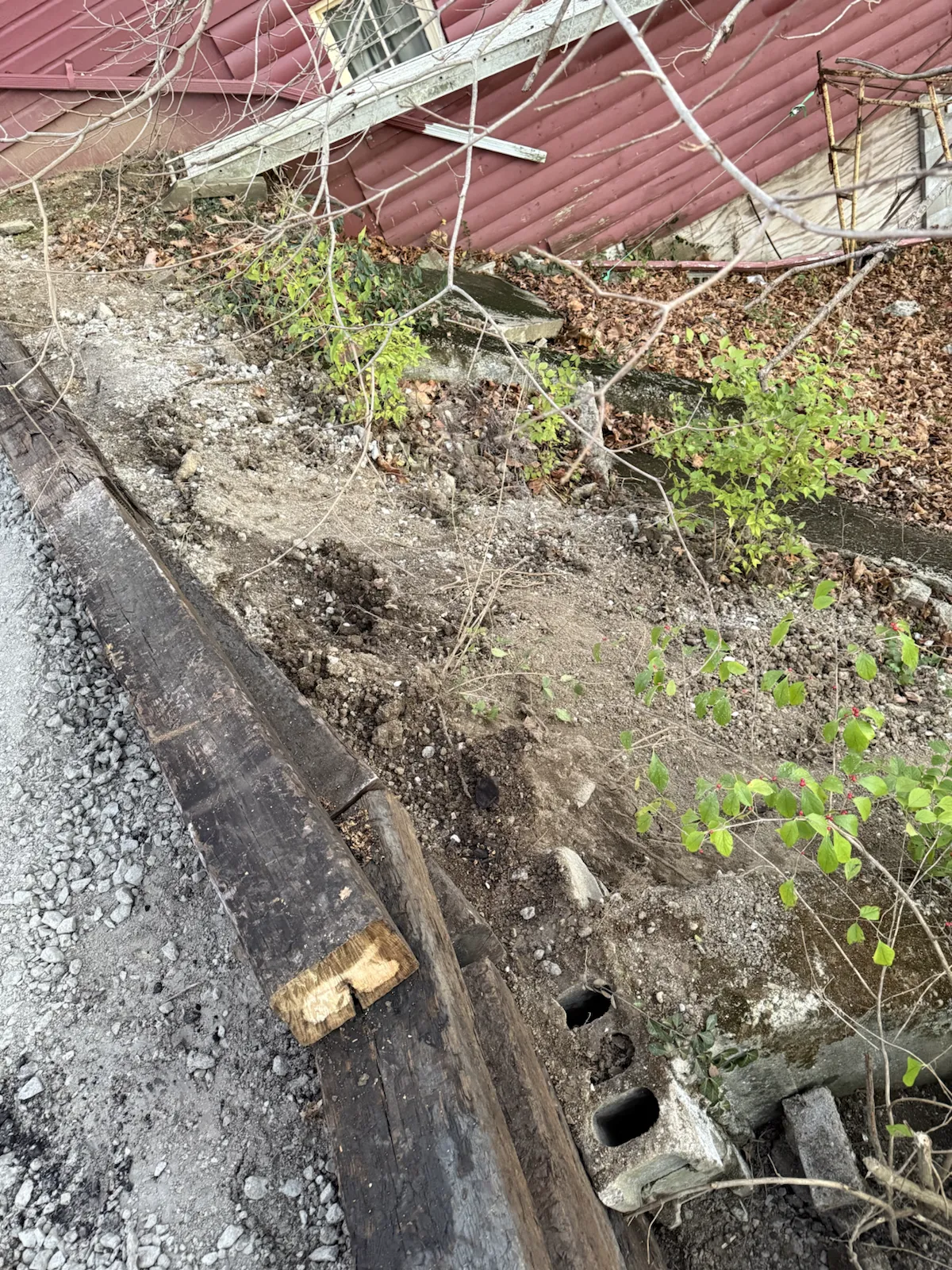 Eroded bank and failing slope before retaining wall and gravel work in central Indiana (photo 8)