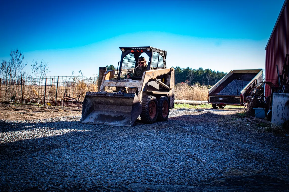 Skid steer working a gravel driveway in Morristown, Indiana